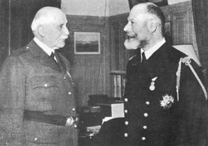 L'amiral Estéva, “ le saint de la Marine ”, est reçu par le maréchal Pétain à son retour de Tunisie, le 20 mai 1943. 